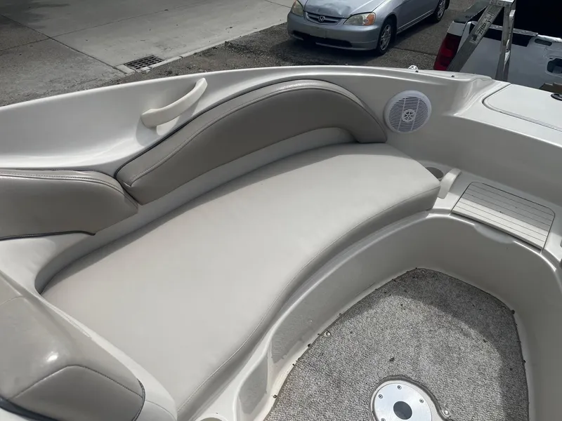 Slide: The Image of 2004 Sea Ray 220 Sundeck interior with cushioned seating and speaker. - 6