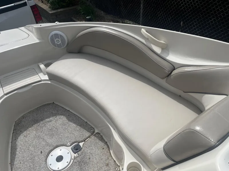 Slide: The Image of 2004 Sea Ray 220 Sundeck boat interior with cushioned seating and speaker. - 7