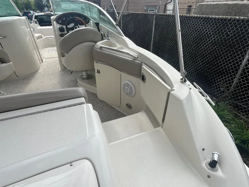 Slide: The Image of 2004 Sea Ray 220 Sundeck interior with steering wheel and seating area. - 8