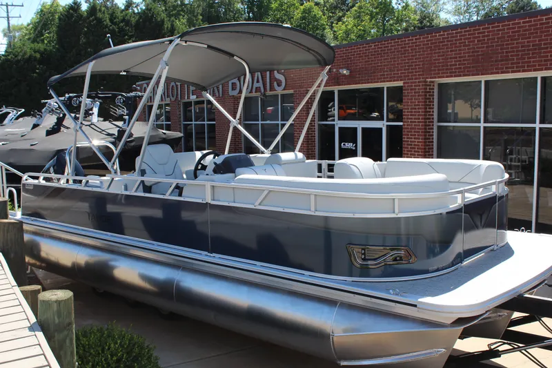 The Image of 2025 Tahoe Pontoon Sport 85 Versatile Rear Bench boat displayed outdoors. - 0