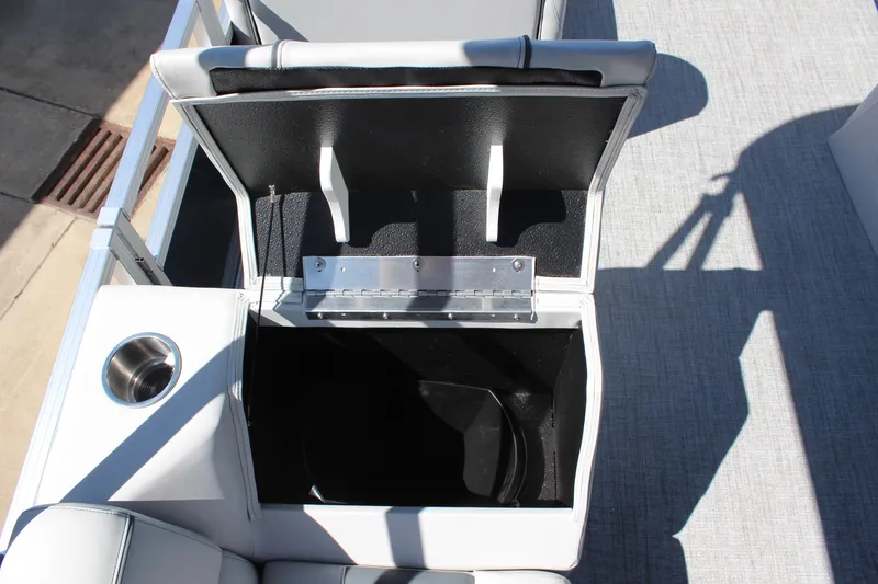 Slide: The Image of 2025 Tahoe Pontoon Sport 85 Versatile Rear Bench storage compartment with open lid and cup holder. - 11