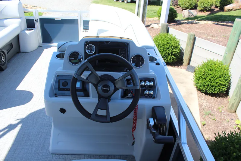 Slide: The Image of 2025 Tahoe Pontoon Sport 85 Versatile Rear Bench helm with steering wheel and controls. - 8