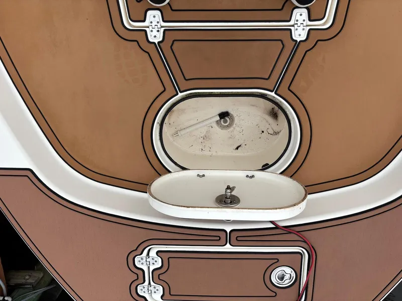 Slide: The Image of 2020 Pathfinder 2600 HPS boat deck with storage compartments and sink. - 11