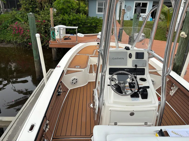 Slide: The Image of 2020 Pathfinder 2600 HPS boat with Garmin navigation, docked near a wooden pier. - 14