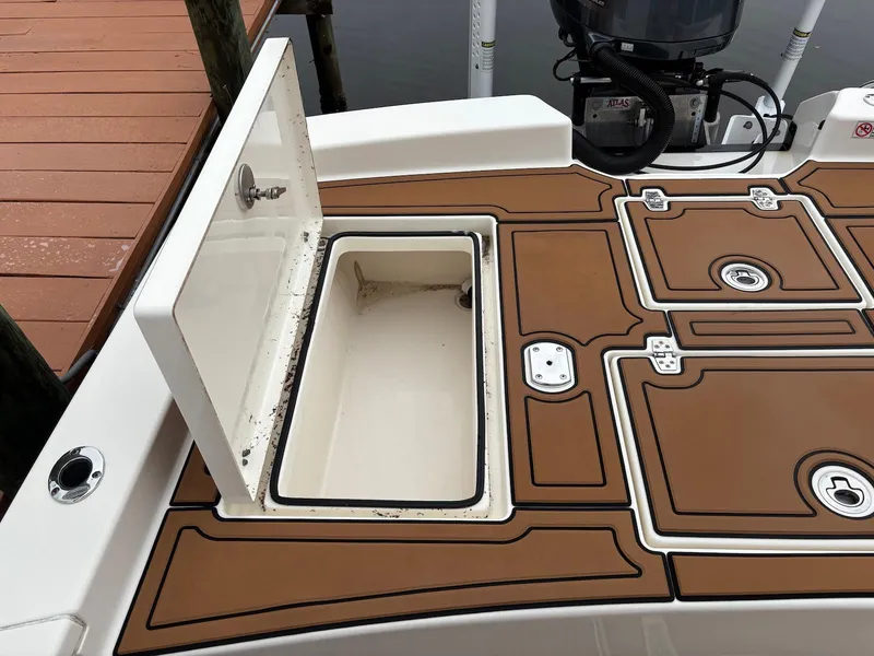 Slide: The Image of Open storage compartment on a 2020 Pathfinder 2600 HPS boat deck. - 16