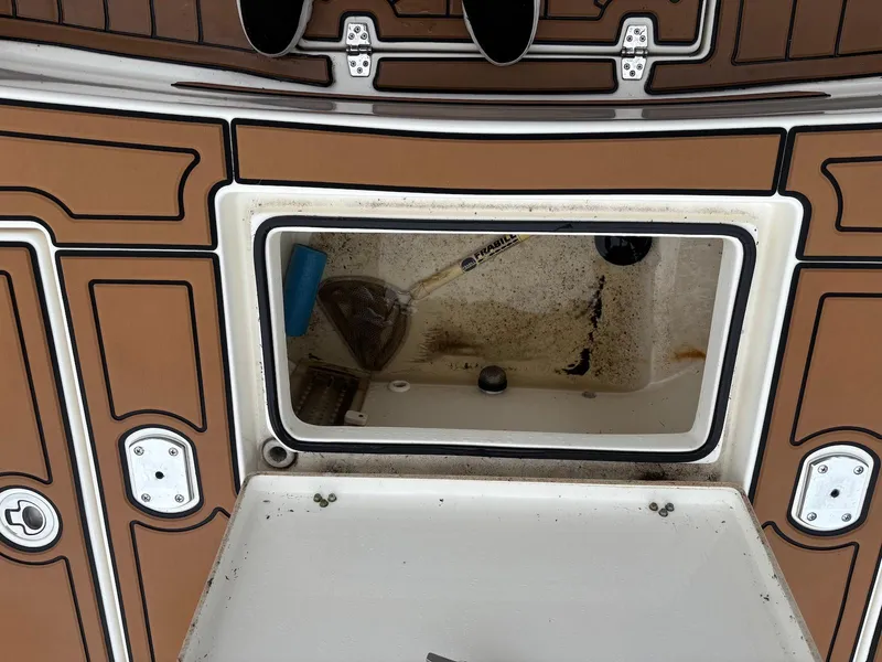 Slide: The Image of 2020 Pathfinder 2600 HPS boat storage compartment with brown and white interior detailing. - 17