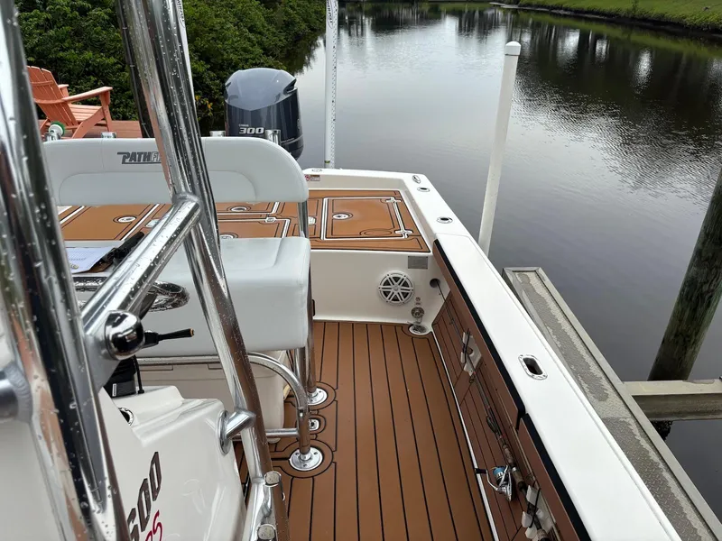 Slide: The Image of 2020 Pathfinder 2600 HPS boat interior with teak flooring and water view. - 20