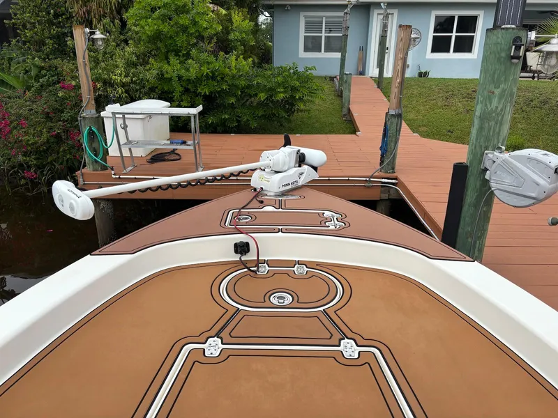 Slide: The Image of 2020 Pathfinder 2600 HPS boat docked, featuring a brown deck and trolling motor. - 22