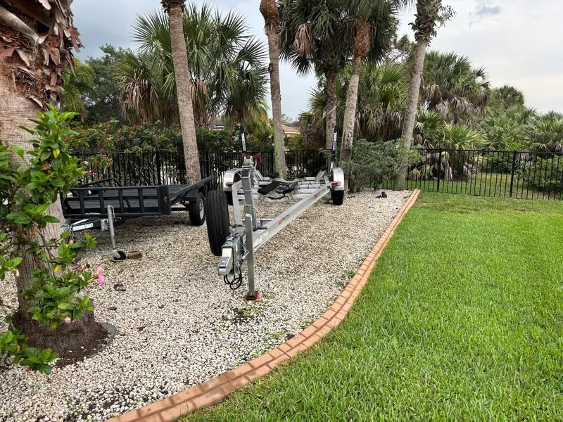 Slide: The Image of Boat trailer parked on gravel near palm trees, 2020 Pathfinder 2600 HPS model. - 24