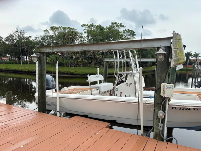 Slide: The Image of 2020 Pathfinder 2600 HPS boat docked by a wooden pier on a calm river. - 4