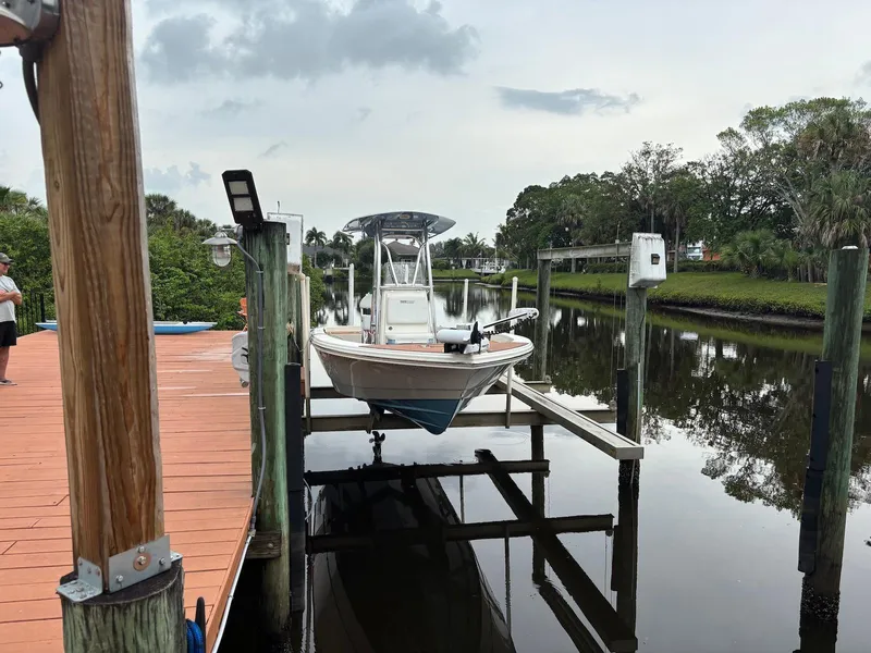 Slide: The Image of 2020 Pathfinder 2600 HPS boat docked on a lift by a calm river. - 5