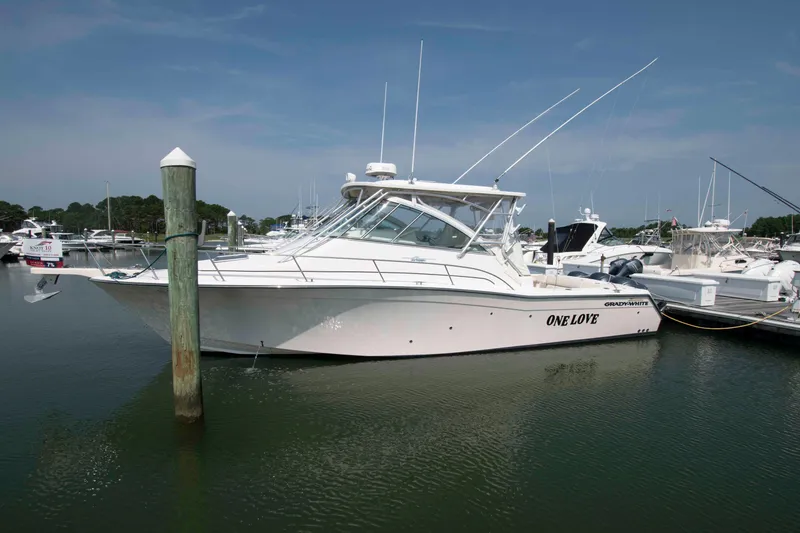 Slide: The Image of 2006 Grady-White Express 360 boat docked in a marina, named "One Love". - 1