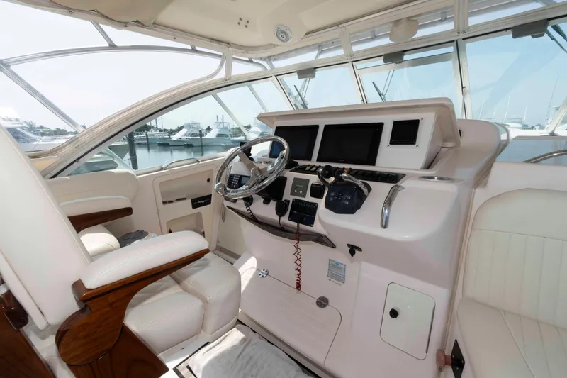 Slide: The Image of 2006 Grady-White Express 360 boat cockpit with steering wheel and control panel. - 11