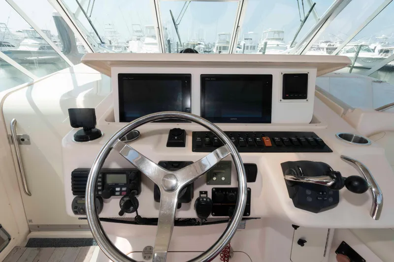 Slide: The Image of 2006 Grady-White Express 360 helm with steering wheel and navigation controls. - 13