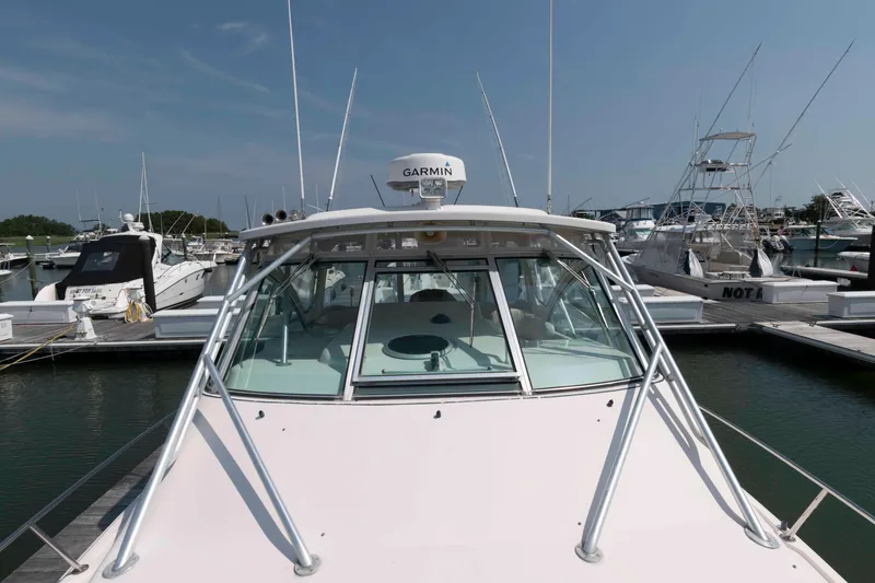 Slide: The Image of 2006 Grady-White Express 360 boat docked at marina, clear sky background. - 18