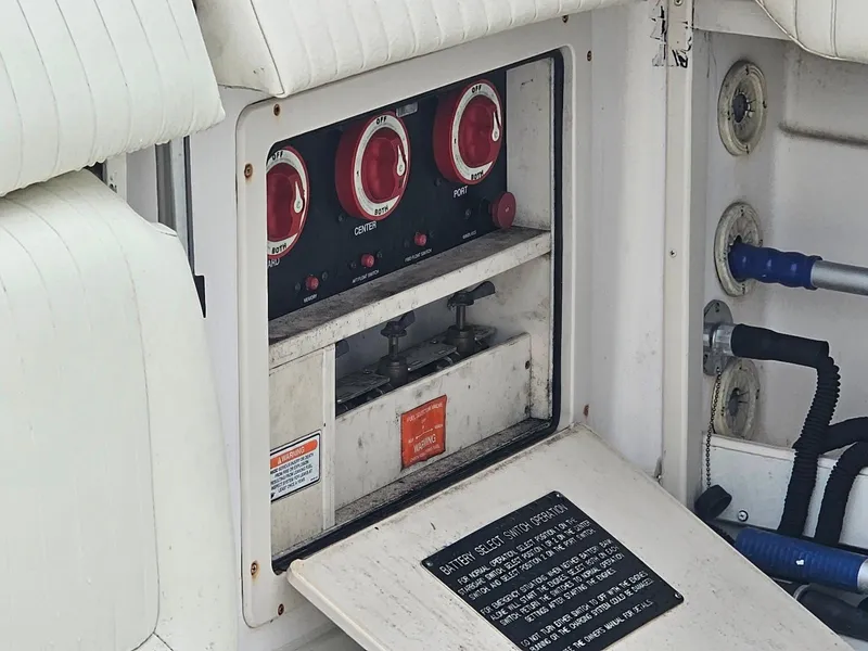Slide: The Image of Control panel of a 2006 Grady-White Express 360 boat with red switches. - 19