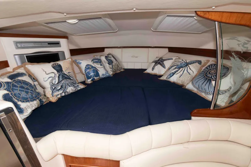 Slide: The Image of Luxurious 2006 Grady-White Express 360 cabin with nautical-themed pillows and cozy bedding. - 23