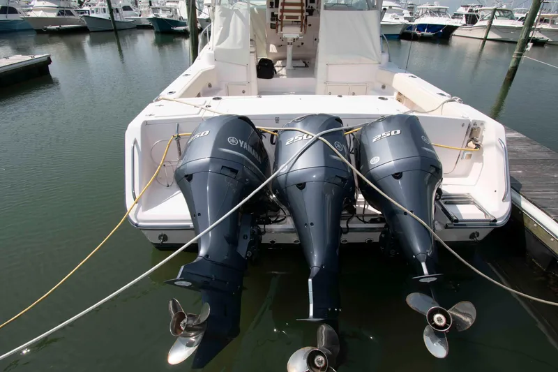 Slide: The Image of 2006 Grady-White Express 360 boat with triple Yamaha 250 engines docked at marina. - 27