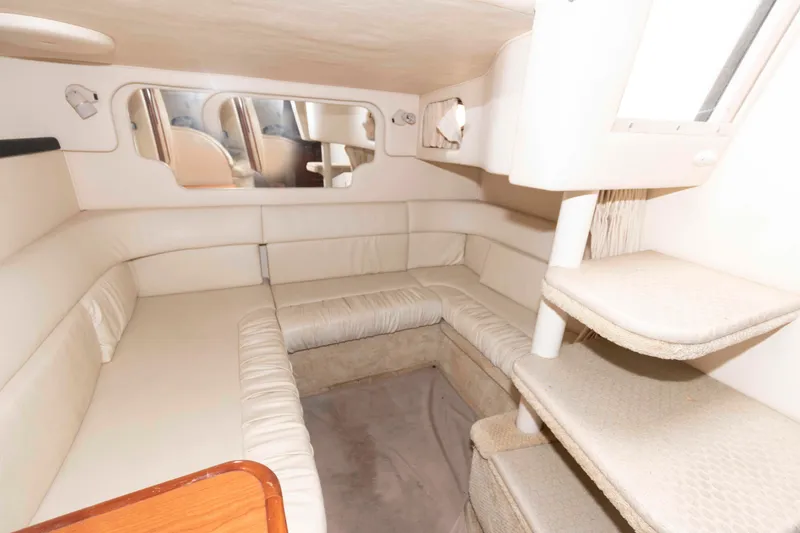 Slide: The Image of Interior of 2001 Sea Ray 340 Sundancer, featuring beige seating and compact design. - 12