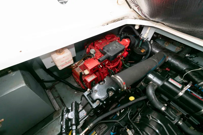 Slide: The Image of Engine compartment of a 2001 Sea Ray 340 Sundancer boat, featuring a red engine. - 15