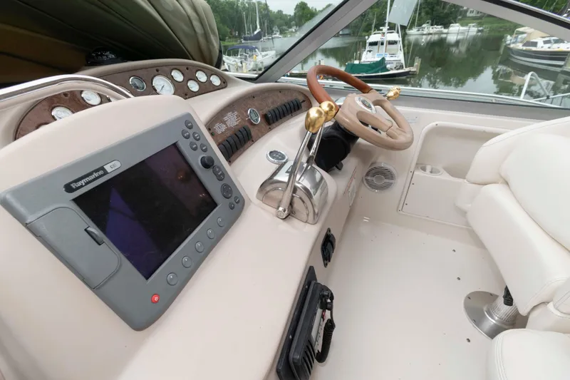 Slide: The Image of 2001 Sea Ray 340 Sundancer helm with Raymarine GPS and luxurious steering wheel. - 5