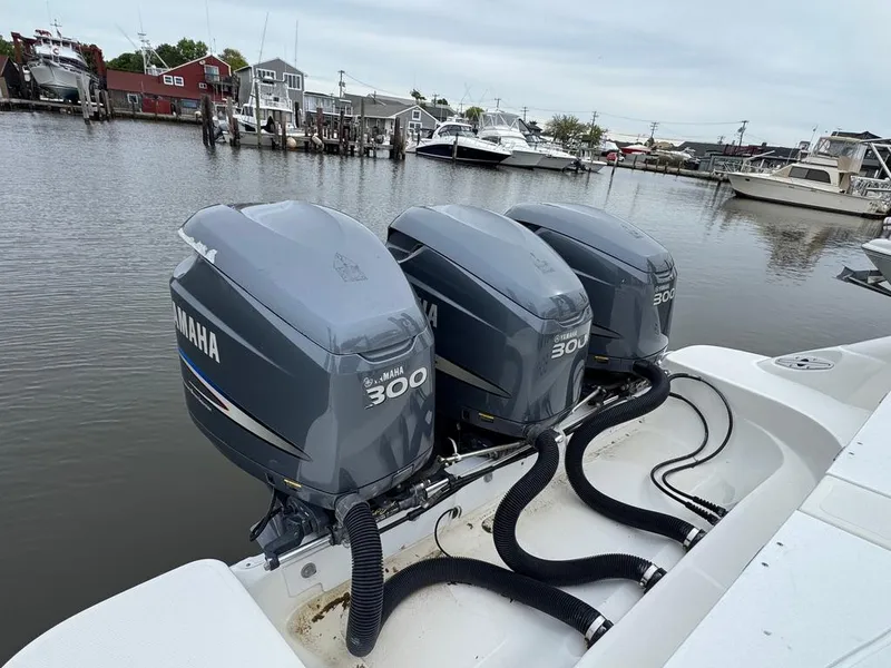 Slide: The Image of 2004 Wellcraft Scarab Fisherman CCF 35 with triple Yamaha 300 engines docked in a marina. - 10
