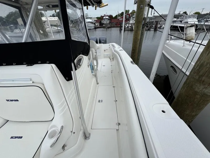 Slide: The Image of 2004 Wellcraft Scarab Fisherman CCF 35 boat docked at marina, featuring spacious deck. - 11