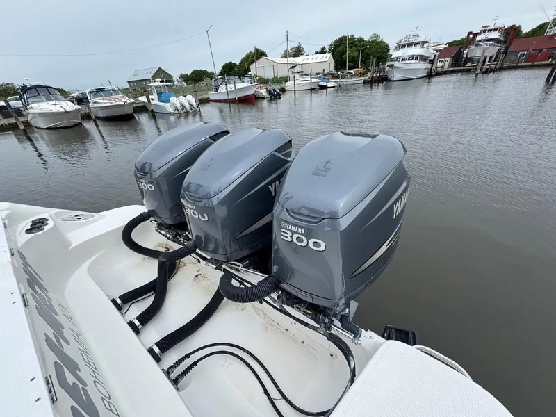 Slide: The Image of Triple Yamaha 300 engines on a 2004 Wellcraft Scarab Fisherman CCF 35 at a marina. - 13