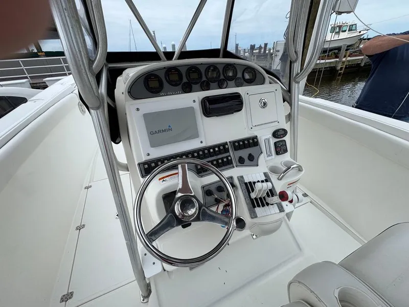 Slide: The Image of 2004 Wellcraft Scarab Fisherman CCF 35 boat dashboard with steering wheel and controls. - 14