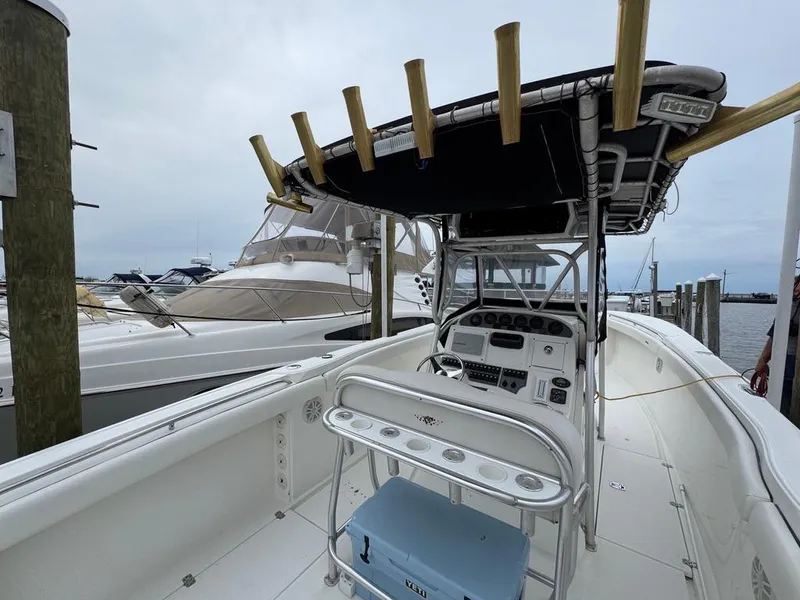 Slide: The Image of 2004 Wellcraft Scarab Fisherman CCF 35 boat docked, featuring a spacious deck and control console. - 16