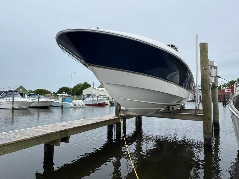 Slide: The Image of 2004 Wellcraft Scarab Fisherman CCF 35 boat docked at marina, side view. - 20