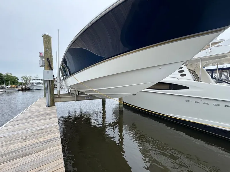 Slide: The Image of 2004 Wellcraft Scarab Fisherman CCF 35 boat docked, showcasing sleek hull design. - 3