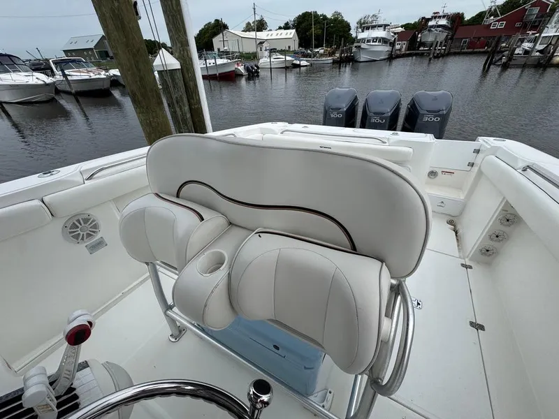 Slide: The Image of 2004 Wellcraft Scarab Fisherman CCF 35 boat interior with white seating and triple outboard engines. - 5