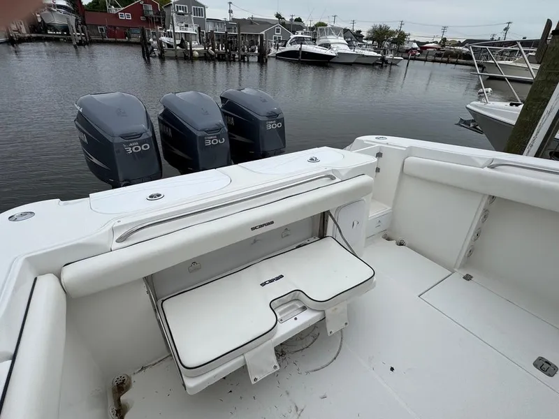 Slide: The Image of 2004 Wellcraft Scarab Fisherman CCF 35 boat with triple 300 horsepower engines docked by the water. - 6