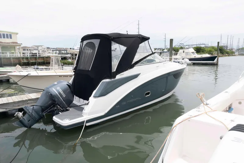 The Image of 2019 Regal 26 XO boat docked with black canopy and Yamaha outboard motor. - 0