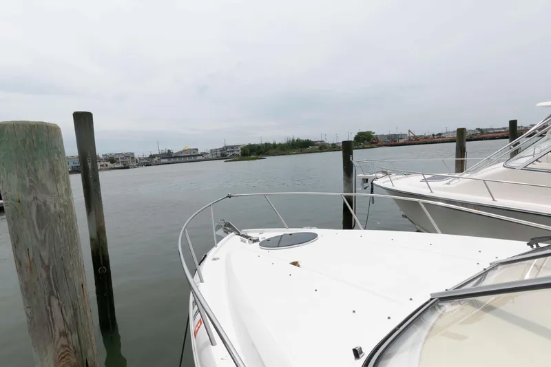 Slide: The Image of 2019 Regal 26 XO boat docked at a marina with calm waters. - 10