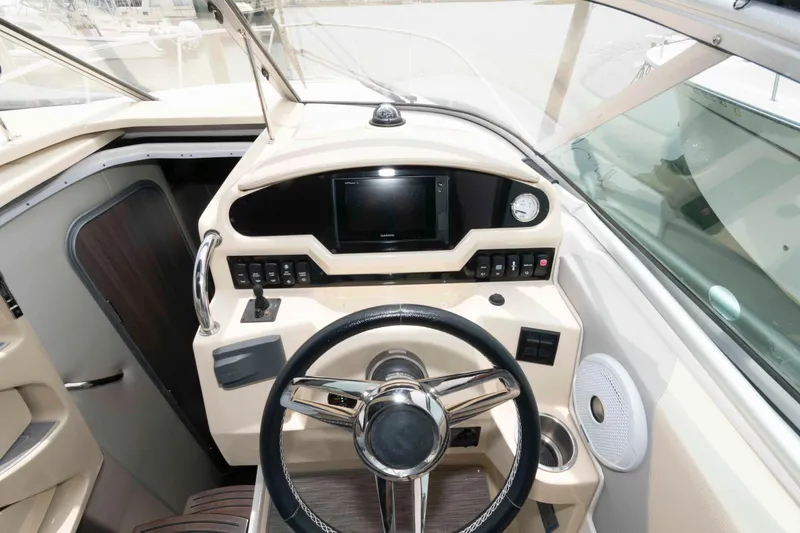 Slide: The Image of 2019 Regal 26 XO boat helm with steering wheel and control panel. - 6