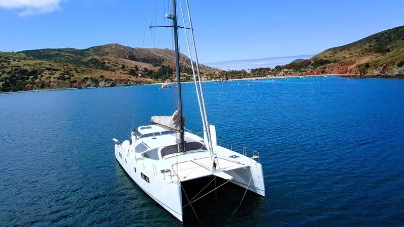 Slide: The Image of 2011 Performance Catamarans 52 sailing in a scenic bay with hills in the background. - 11