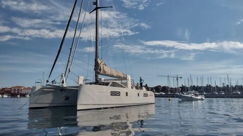 Slide: The Image of 2011 Performance Catamarans 52 sailing on calm waters under a clear blue sky. - 14