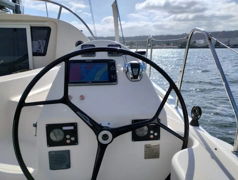 Slide: The Image of Helm of 2011 Performance Catamarans 52 with navigation equipment, steering wheel, and ocean view. - 19
