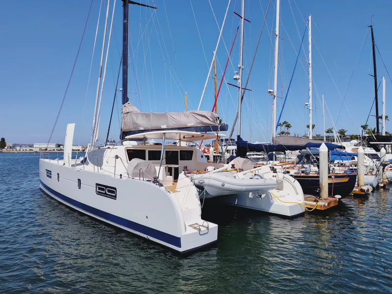 Slide: The Image of 2011 Performance Catamarans 52 docked in a marina under clear blue skies. - 2