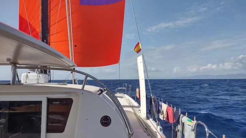 Slide: The Image of 2011 Performance Catamarans 52 sailing with vibrant orange sails on open sea. - 21