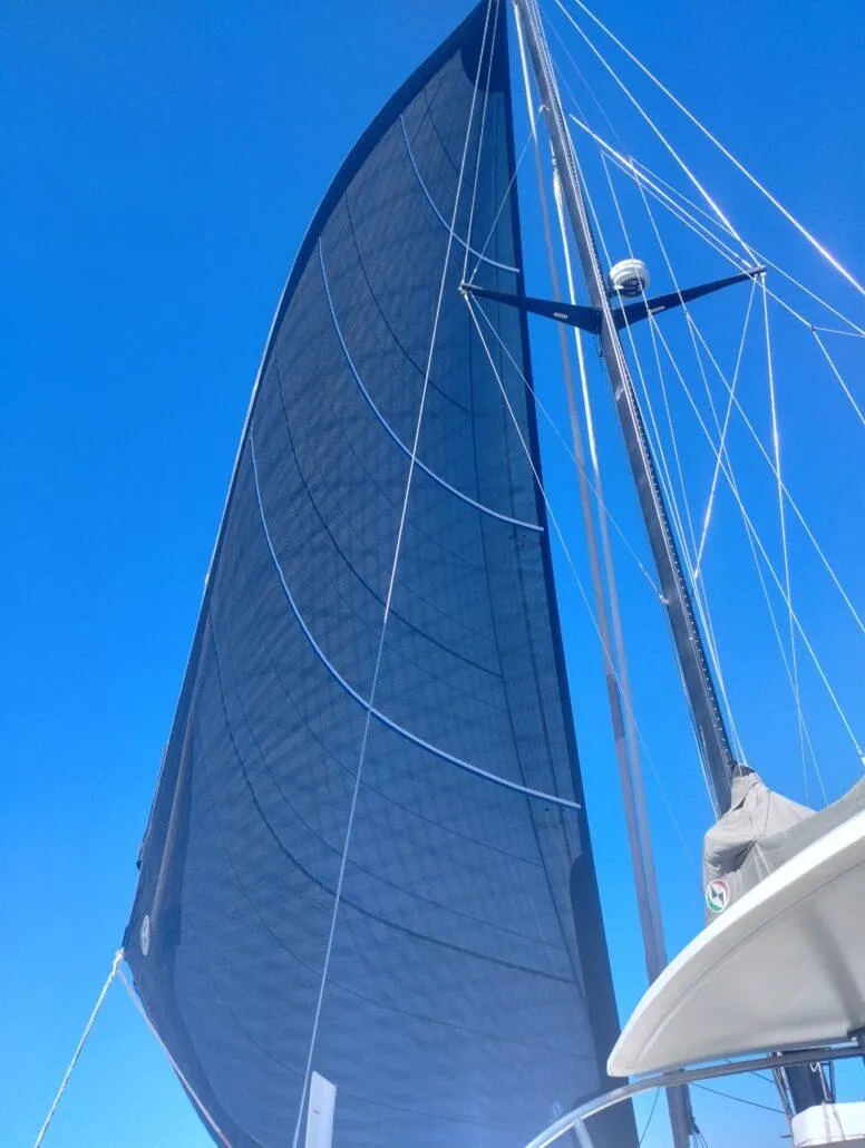 Slide: The Image of Sailing catamaran with large black sail against clear blue sky, Performance Catamarans 52, 2011 model. - 24