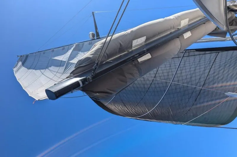 Slide: The Image of Sailing catamaran with sails unfurled against a clear blue sky, Performance Catamarans 52, 2011 model. - 25