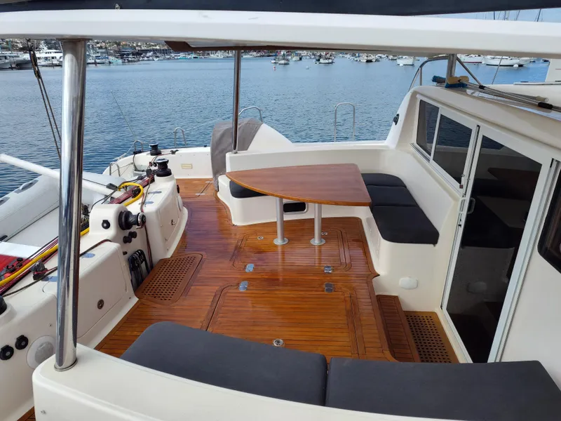 Slide: The Image of Spacious deck of 2011 Performance Catamarans 52 with seating and table, overlooking marina. - 28