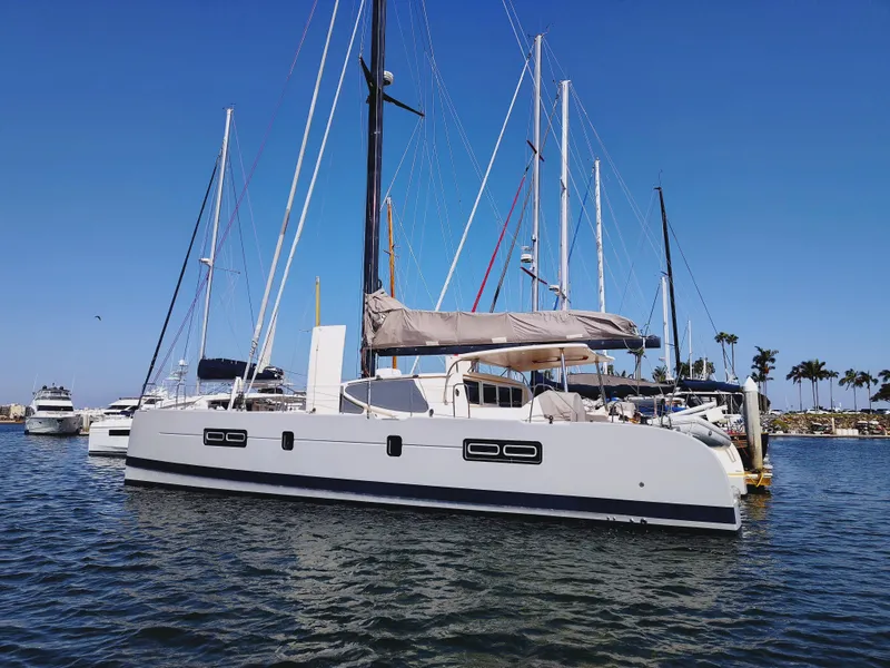 Slide: The Image of 2011 Performance Catamarans 52 docked in a marina under clear blue skies. - 3