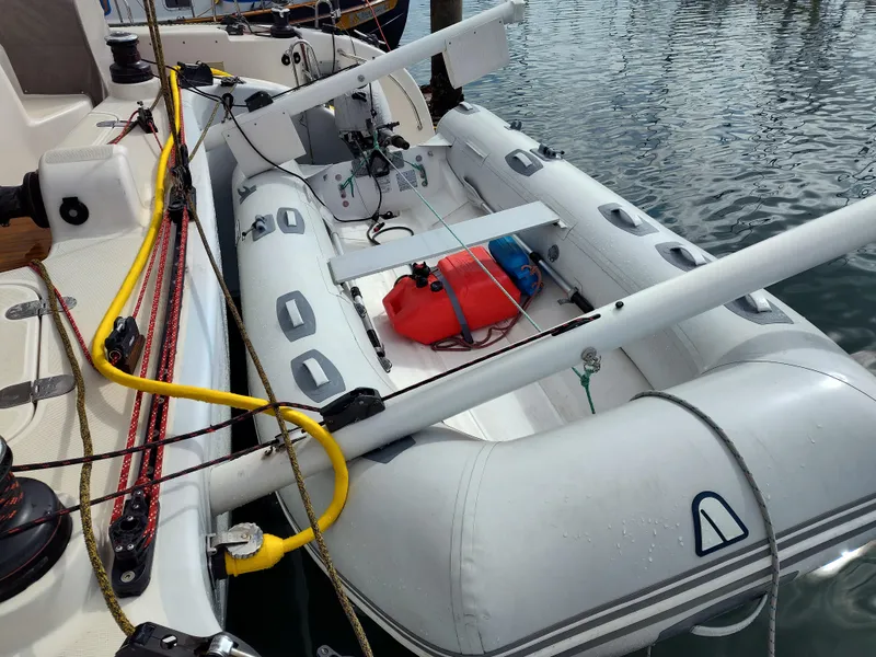 Slide: The Image of Inflatable dinghy on Performance Catamarans 52, 2011 model, docked by water. - 33