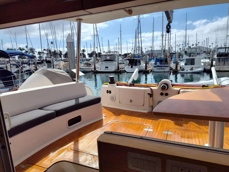 Slide: The Image of Luxurious 2011 Performance Catamarans 52 docked at a marina, featuring spacious deck seating. - 36