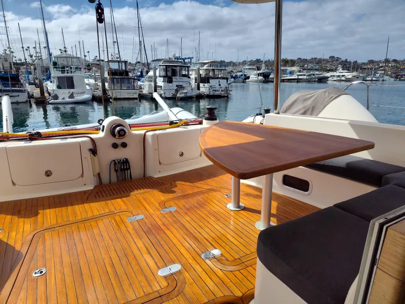Slide: The Image of 2011 Performance Catamarans 52 with teak deck and seating, docked in a marina. - 37