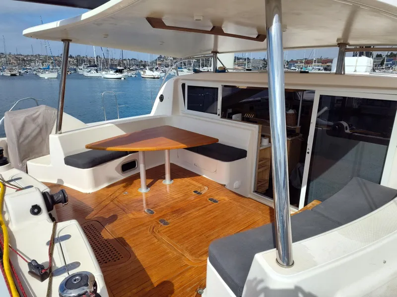 Slide: The Image of Spacious deck of 2011 Performance Catamarans 52 with seating and table, docked in marina. - 39